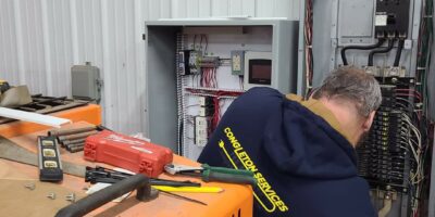 Congleton Services pulling wire to a 20 bus block heater controller in Mitchell Indiana school